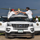 Researchers load instrumentation onto a tracker vehicle before a drone’s takeoff.